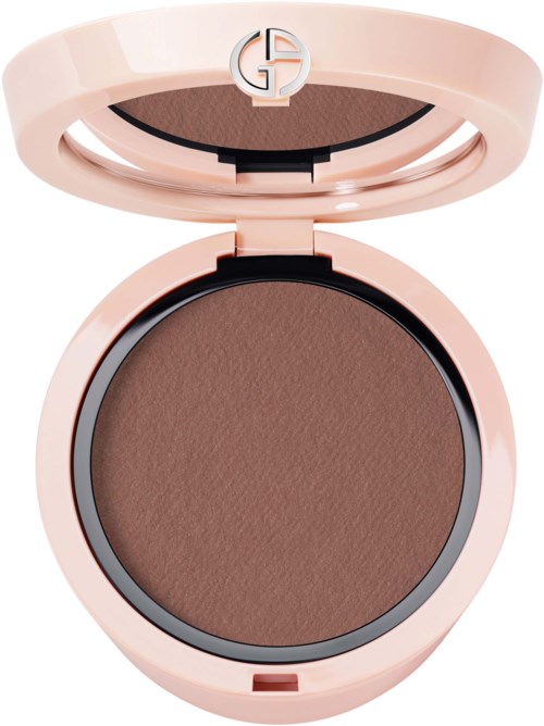 Ett runt makeup-förpackning med ett rosa skal och ett brunt pressat puder inuti.