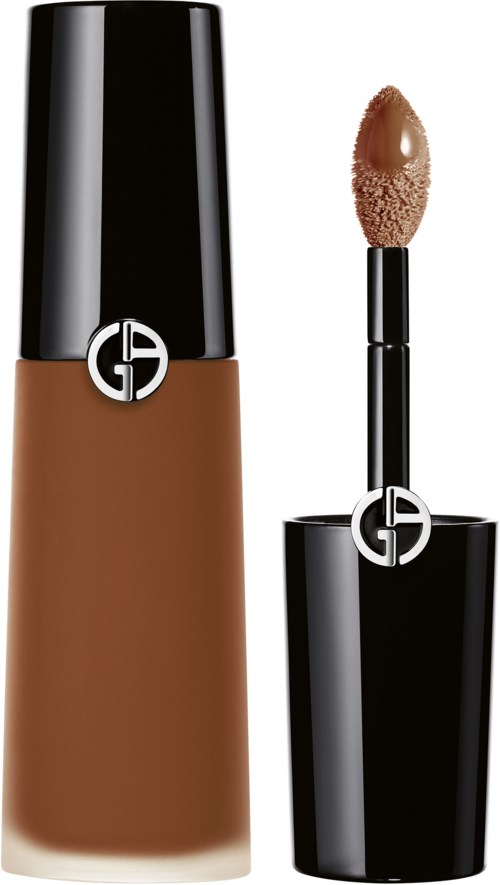 A bottle of liquid foundation and an applicator with a sponge for makeup.