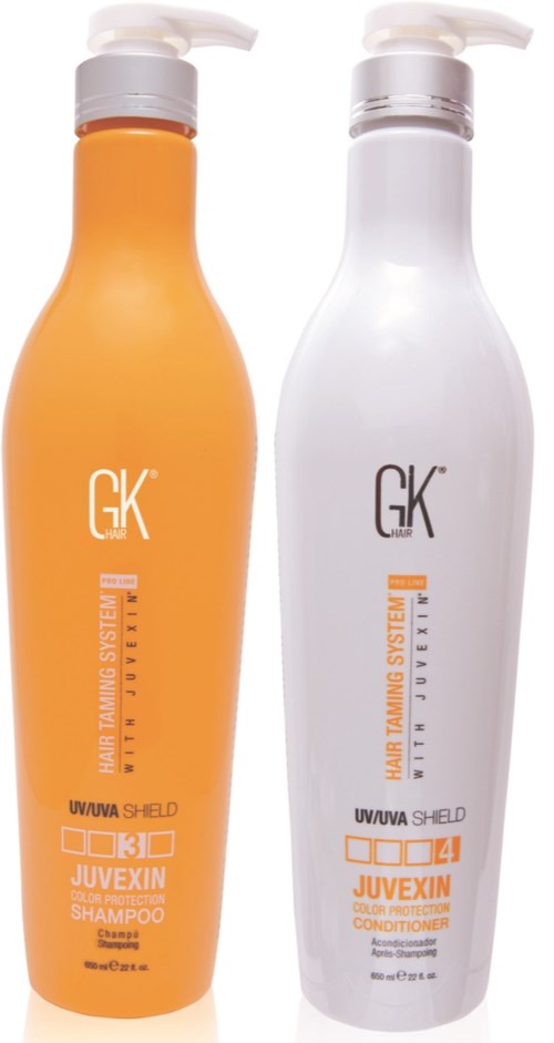 Two bottles of hair care products, one orange shampoo and one white conditioner, with pump tops, labeled 'GK JUVEXIN'.