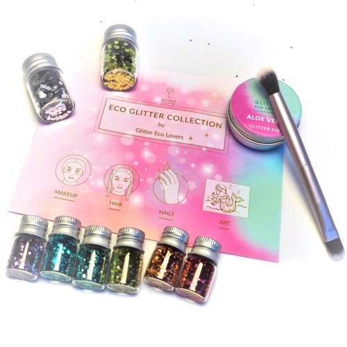 Små flaskor med glitter, en makeupborste och ett pink-blått informationskort om ekologists glitterkollektion.