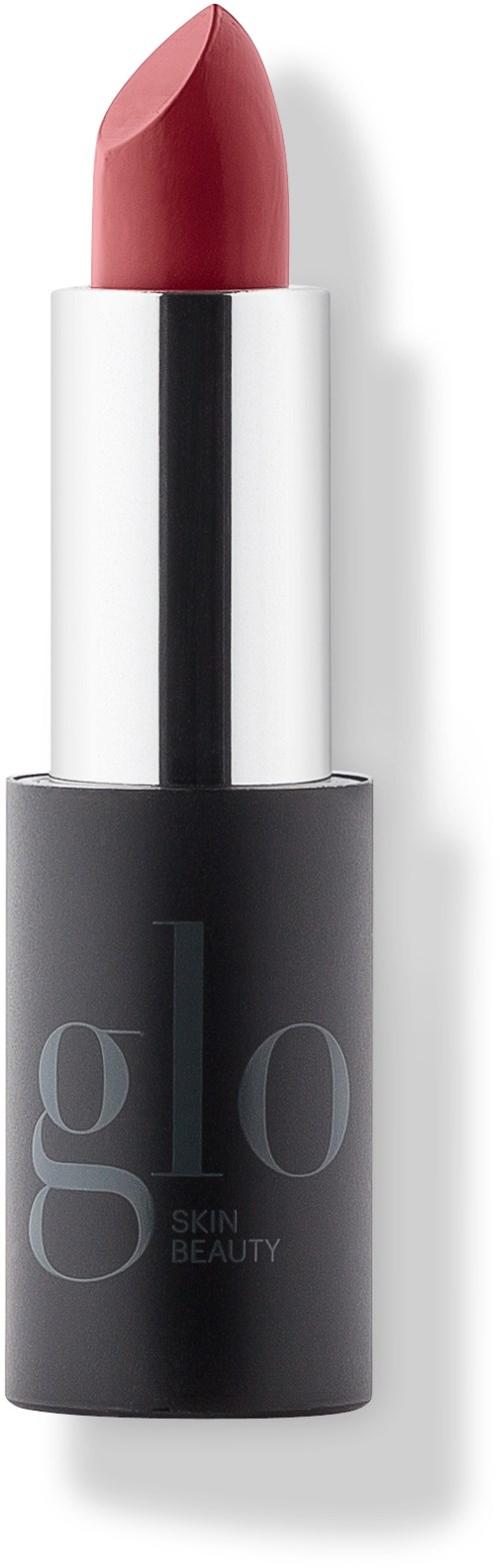 A lipstick with a soft pink color, black and white packaging, and the words "Glo Skin Beauty".