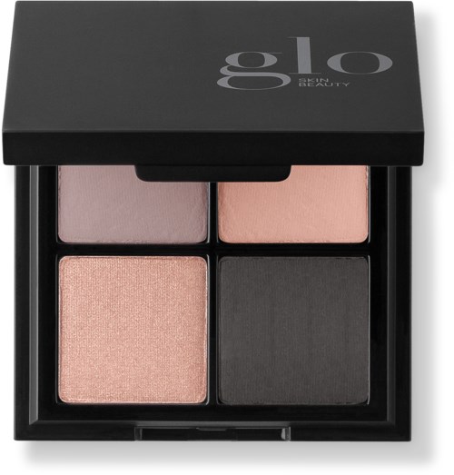En makeup-palett med fyra färgkuber: rosa, persika, ljus lavendel och mörkgrått i ett svart fodral.