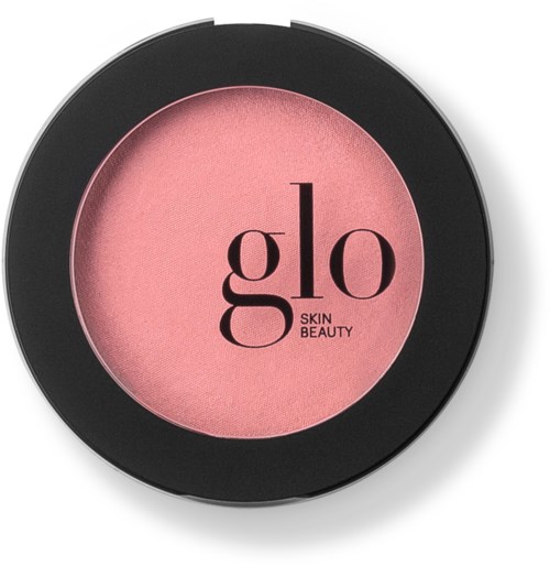Rosa blush i en rund svart förpackning med orden "glo SKIN BEAUTY" tryckta på den.