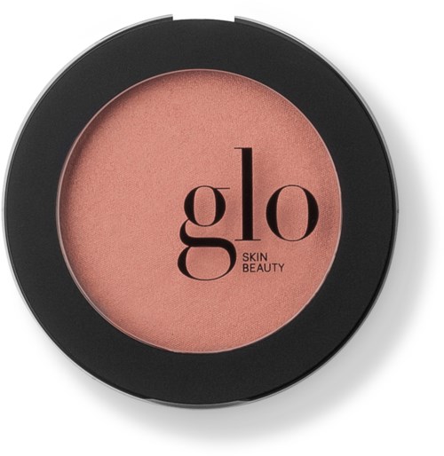 Een ronde make-upproduct met een roze tint in een zwart bakje, gelabeld 'glo Skin Beauty'.