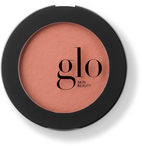 Een compacte blush met de merknaam 'glo Skin Beauty' op het oppervlak in zwarte tekst.