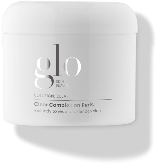 En hvit krukke med Clear Complexion Pads for hud, med merkevaren 'glo' og beskrivelse av produktets funksjoner.