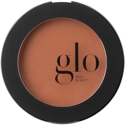 En rund liten burk med svart ytterkant och beige/orange inuti. Den har ordet 'glo' och 'SKIN BEAUTY' på sig.