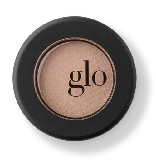 En rund ögonskuggaskompakt med svart ytterhölje och ordet "glo" i mitten.
