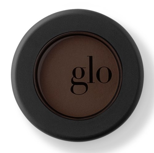 En svart rund behållare med en mörkbrun produkt märkt 'glo' i mitten.