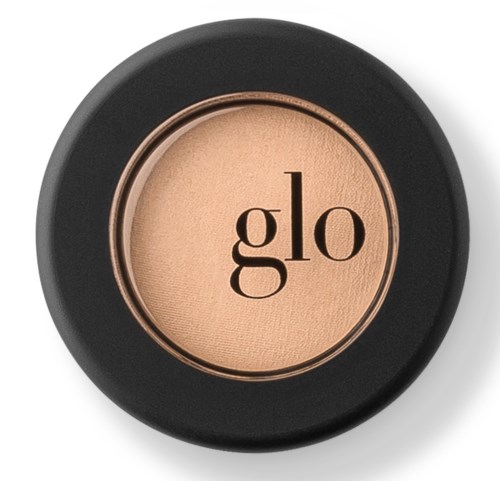 Ett kompakt, runt sminkrouge med svart förpackning och "glo" skrivet i mitten.