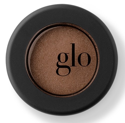En rund ögonskugga med brunt färg och svart kant, visar varumärkesnamnet 'glo' i mitten.