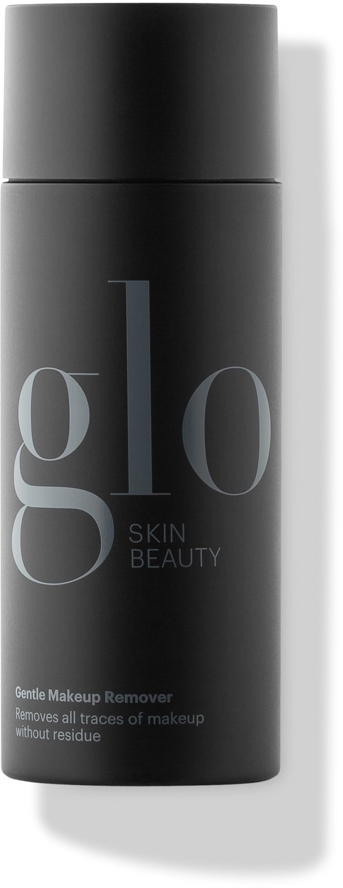 En svart sylinderformet flaske med sølvlokk merket 'glo Skin Beauty', brukt til forsiktig fjerning av sminke.