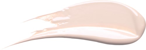 En kremaktig, lys beige substans spredt utover en hvit overflate med noen striper og glatt utseende.