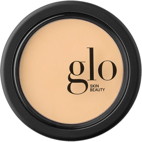 Een ronde container met een beige product erin. Het label zegt "glo Skin Beauty."