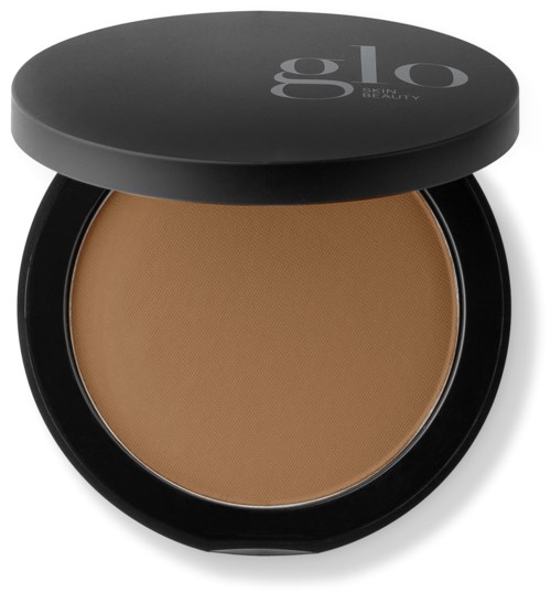 En pressed powder-kompakt med svart lokk og ordet 'glo' på, trolig bruk for sminke.
