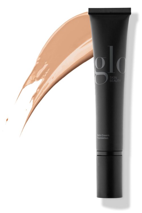 En svart tube med foundation med beige sminke ved siden av.