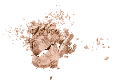 A broken brown object with small particles scattered around, possibly a crushed snack or chalk piece.