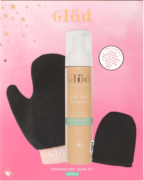 A makeup kit includes self-tan mousse, a mitt, and an applicator sponge, all on pink background with gold stars.