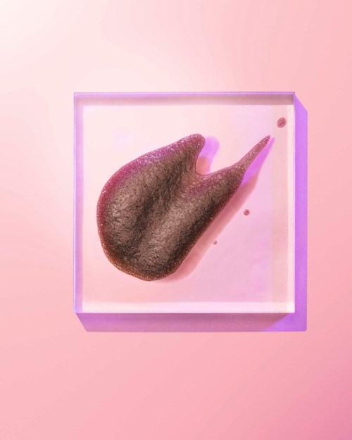 A dark, abstract, teardrop-shaped object inside a clear square frame, glowing with pink and purple light.