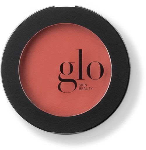 En kompakt rund blush med svart kant och rosa färg inuti, märkt "glo SKIN BEAUTY."