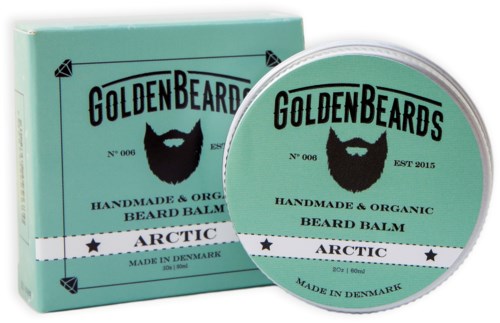 En grön box och ett runt behållare med skäggbalsam med svart skägglogga och text, tillverkad i Danmark.