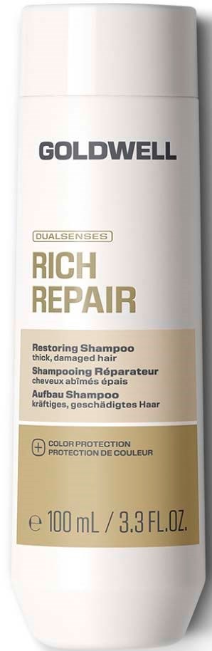 En vit flaska med Goldwell Rich Repair Restoring Shampoo för tjockt, skadat hår med gul och svart text.