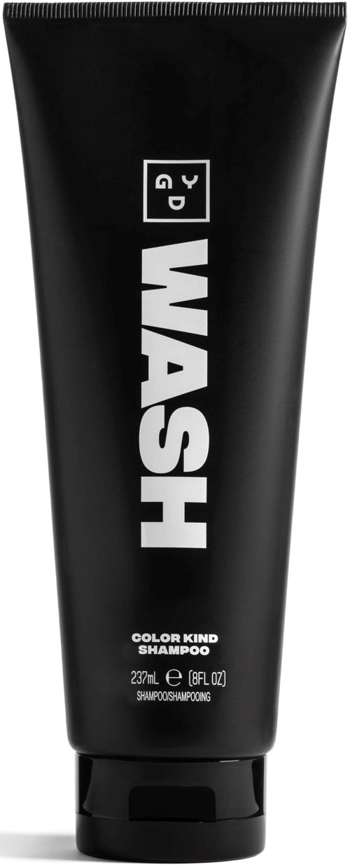 A black shampoo tube with bold white text that says 'WASH' and additional product information at the bottom.