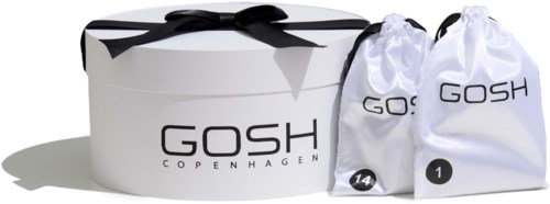 A white gift box with a black bow and two white bags labeled "GOSH" and numbers, likely containing beauty products.