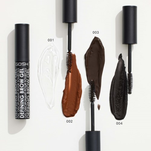 Fire makeup-produkter med forskellige farvede cremer og sorte børster på hvid baggrund.
