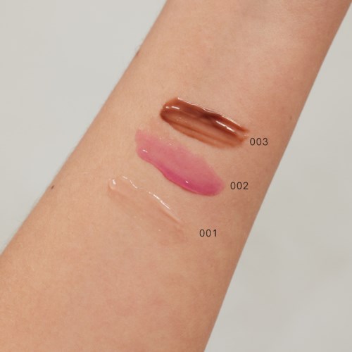 Three different shades of makeup swatched on skin, from light to dark, labeled 001, 002, 003.