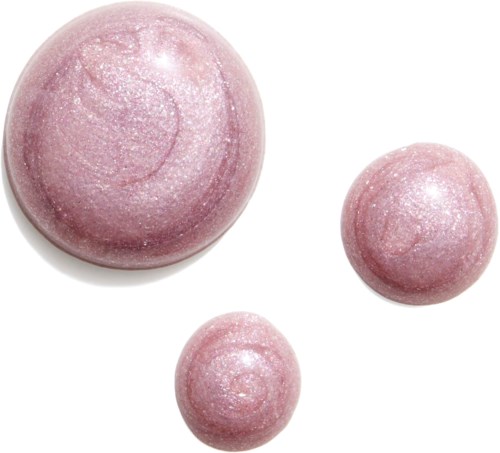 Three pink, sparkly, round objects of different sizes, casting light reflections.