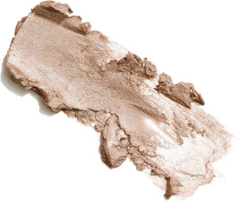 Krossad beige puder spridd i en grov, ojämn form med en tårad kant. Ser ut som makeup eller en mineralprodukt.
