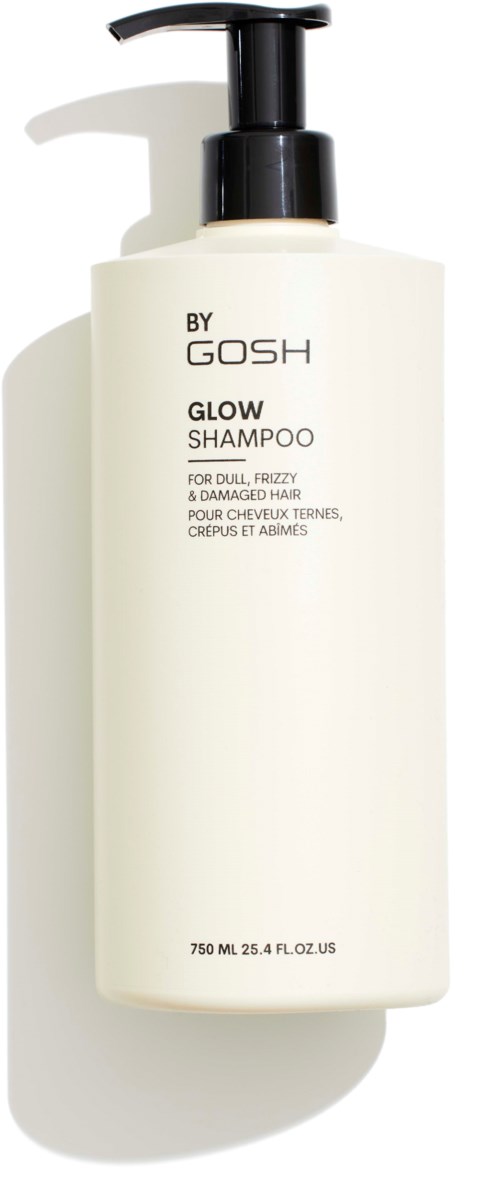 Valkoinen shampoopullo mustalla pumpulla, merkintä 'BY GOSH GLOW SHAMPOO' himmeälle, mörröiselle, vaurioituneelle hiukselle.