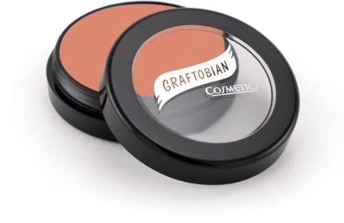 Två runda förpackningar med svarta lockar, en öppen och visar blek persikofärgad makeup.