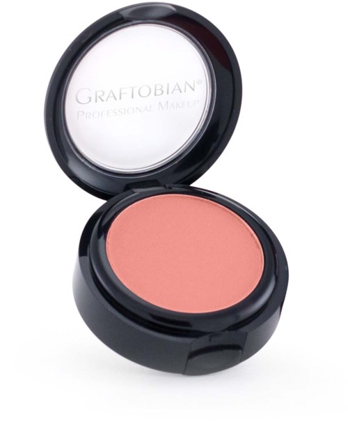 A round makeup compact with peach blush, open lid showing the brand GRAFTOBIAN and product type.