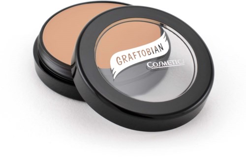 A compact container with beige makeup and a clear lid, labeled Graftobian Cosmetic. It is open showing the powder.