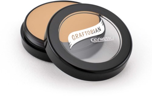 A round black container with a clear lid, labeled 'GRAFTOBIAN' and 'COSMETIC', holding beige makeup powder.