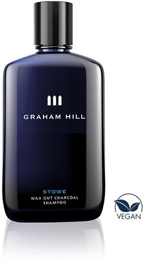Mørk blå sjampoflaske merket Graham Hill Stowe Wax Out Charcoal Shampoo med vegansymbol.
