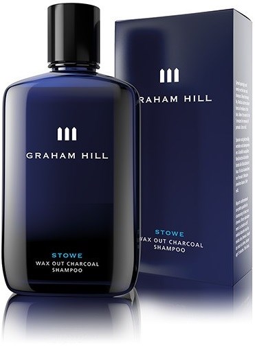 En mørk blå sjampoflaske og eske merket Graham Hill Stowe Wax Out Charcoal Shampoo.