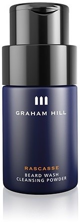 Tummansininen pullo mustalla korkilla, jossa lukee 'Graham Hill' ja 'Rascasse Beard Wash Cleansing Powder'.