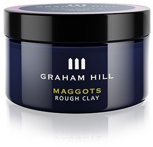 Et krukke Graham Hill Maggots Rough Clay hårprodukt, mørk blå med sort låg og hvid tekst.