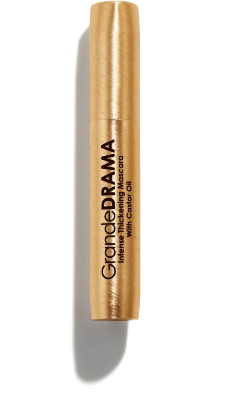 Een goudkleurige tube van GranderDrama lipgloss met kokosolie, afgebeeld met schaduw op een witte achtergrond.
