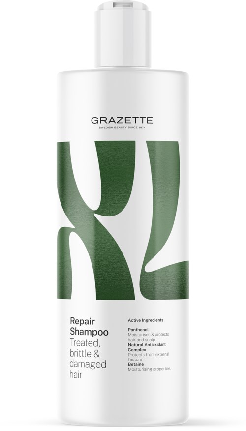 A white bottle with large green letters and text, labeled as repair shampoo for damaged hair.
