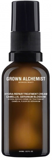 En liten brun flaske med svart sprayhette, merket 'Grown Alchemist Hydra-Repair Treatment Cream' med planteingredienser.