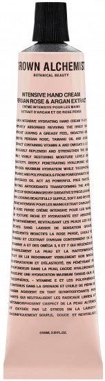 En tube med håndkrem med svart lokk og rosa emballasje, med tekst om ingredienser og fordeler.