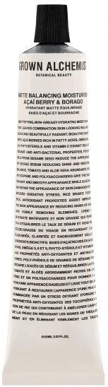 En vit tub med svart lock, märkt 'Crown Alchemy' och 'Botanical Beauty', innehåller en produkt som heter 'Açaí Berry & Borage.'