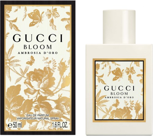 En parfumeflaske og æske med guldblomster og sommerfugldesign, mærket Gucci Bloom Ambrosia D'Oro.