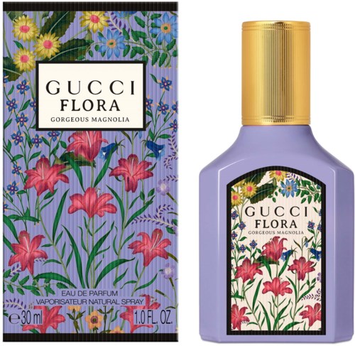 En parfymflaske med lilla krop, guldprop, blomsterlabel og matchende blomstret emballageboks med farverige blomster.