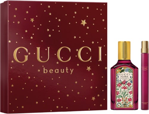 Gucci Beauty set includes a gift box, a floral perfume bottle, and a pink perfume roller. All are luxurious and elegant.
