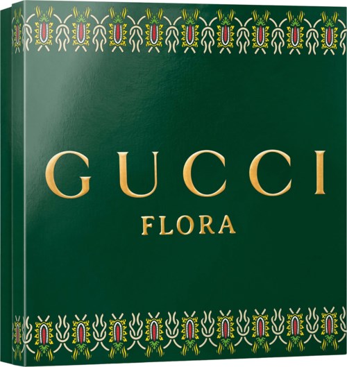 De Gucci Flora parfumdoos met groene achtergrond en gouden tekst, versierd met kleurrijke bloemmotieven boven en onder.